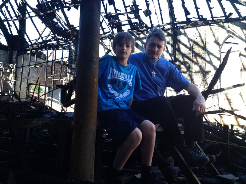 Soren and I sit on the steps of our old boxing ring